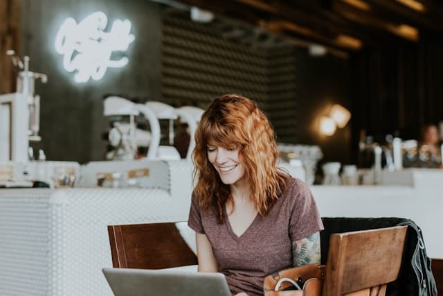 Illustration of a small business owner on a tablet editing their restaurant website, showing the menu page with easy drag-and-drop editing